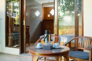 a table with a coffee maker on top of it at Uma Taman House in Ubud