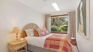 a bedroom with a large bed and a window at Coolburra in Culburra Beach +29 photos