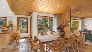 a dining room with a table and chairs at Coolburra in Culburra Beach