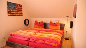 ein Schlafzimmer mit einem Bett mit bunten Kissen in der Unterkunft Art City Studio Kassel 5 in Kassel