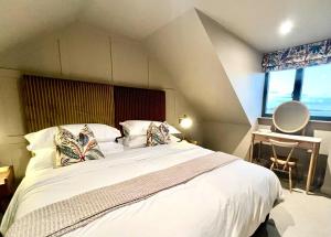 a bedroom with a large white bed with two pillows at Dingle Dell in Great Driffield