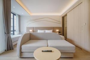 a hotel room with a couch and a bed at Pool View Condo 2204 Wyndham Garden Resort in Nai Thon Beach +31 photos