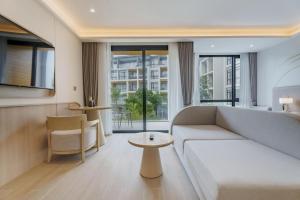 a living room with a couch and a table at Pool View Condo 2204 Wyndham Garden Resort in Nai Thon Beach