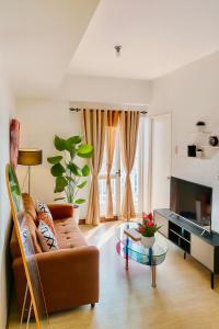 a living room with a couch and a glass table at Vivaldi Residences Cubao VB Infinity Stay-Cubao in Manila