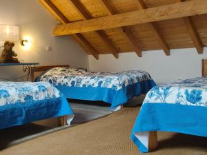 a room with three beds with blue sheets at Domaine du Have in Sainte-Christie-dʼArmagnac +50 photos