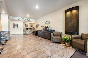 a waiting room with two chairs and a mirror at Comfort Inn & Suites Medina in Medina