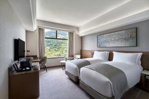 a hotel room with a large bed and a television at Hopewell Hotel in Hong Kong