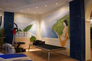 a room with a painting of a woman with an umbrella at Hotel-Landpension Postwirt in Kirchensittenbach