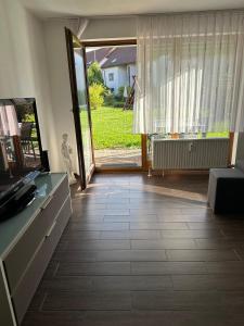 a living room with a large window and a floor at Ferienwohnung Obersulm in Obersulm