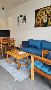 a living room with a blue couch and a table at Serene Zanzibar Retreat with Stunning Pool Beach Access in Paje