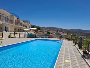 a swimming pool in a villa with a view at ATLANTIS Penthouse Apartment with Jacuzzi plus Pool and Sea Views in Peyia