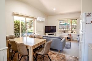 a living room with a table and a couch at Silver Birches Holiday Village - Unit 4 in Bright