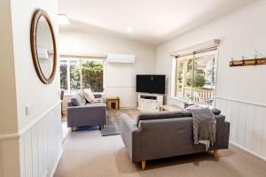 a living room with two couches and a television at Silver Birches Holiday Village - Unit 4 in Bright