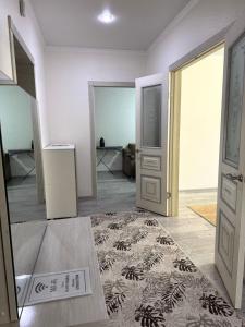 an empty room with an open door and a rug at Near Khan Shatyr in Astana