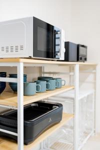 a microwave sitting on top of a shelf at Ishigaki Island villa KURO in Ishigaki Island