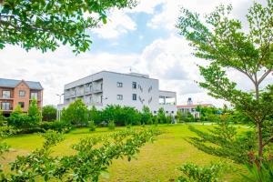 a large white building in a park with trees at Aviavy Hospitality and Special Events in Andakana