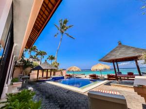 an image of a resort with a swimming pool and the ocean at Villa Talia Vashti - Oceanfront villa with Private Sea Access, Pool & Cook in Candidasa