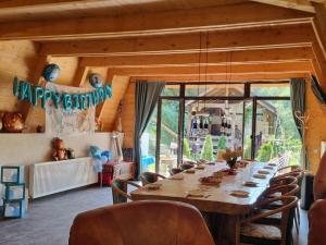 a dining room with a long table and chairs at Cabana Aframe Blidari in Blidari +78 photos