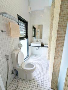 a bathroom with a toilet and a sink at Hoyu''s House B&B in Lugu
