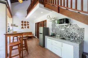 a kitchen with white cabinets and a counter top at Cove Belle Asana in Canggu