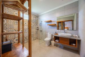 a bathroom with a sink and a toilet and a mirror at Cove Belle Asana in Canggu +20 photos