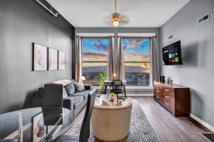a living room with a couch and a table at 1BR Loft Sauna & Walk to Theater & Campus in Cleveland