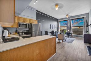 a kitchen with a counter and a living room at 1BR Loft Sauna & Walk to Theater & Campus in Cleveland