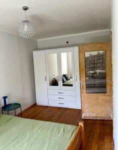 a bedroom with a bed and a mirror in it at Barinu Street Apartment in Liepāja