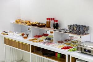 a display case filled with different types of pastries at Potter Hotel Khiva in Khiva