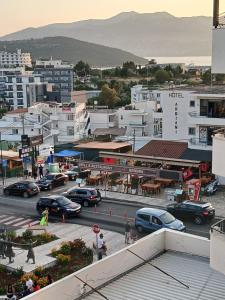 a city with cars parked in a parking lot at Chris Apartment in Ksamil