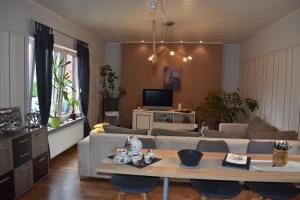 a living room with a couch and a table at Ferienwohnung "Die Auszeit" in Ihlow