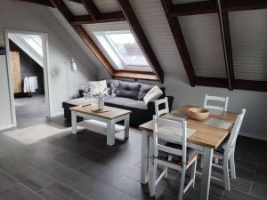 a living room with a couch and a table at Neue Welt Ferienwohnung 1 in Osteel
