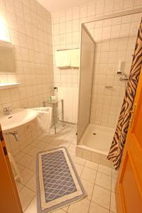 a bathroom with a shower and a sink at CProoms24 in Miesenbach