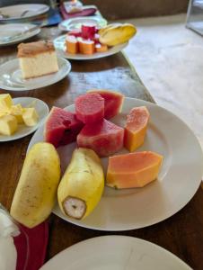 a plate of different types of fruit on a table at Undiya The Neighborhood Sigiriya in Sigiriya