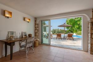 a home office with a desk and a sliding glass door at Casa Cobalto, Sea view, Mediterranean, Sea 700meters, 4 Bedrooms in Benissa