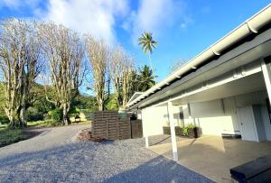 a building with a parking lot next to a road at Pool Villa No 10 in Rarotonga