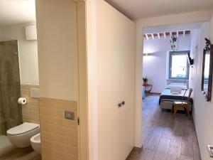 a bathroom with a toilet and a sink in a room at Santa Marta Rooms&Studios in Verona +28 photos