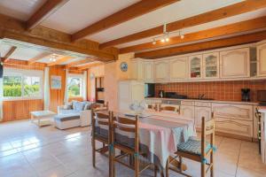 a kitchen with a table and chairs in a room at Maison Yvonne in Plouha +23 photos