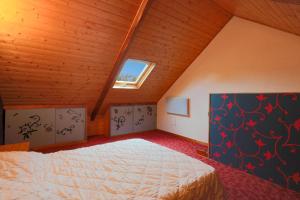 a bedroom with a large bed in a attic at Maison Yvonne in Plouha