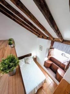 an attic room with a bed and a couch at CHC - Casa La Salvada - Los Silos in Los Silos +20 photos