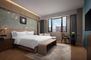 Postel nebo postele na pokoji v ubytování Shanghai Pujiang Vanno Hotel