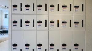 a row of white lockers in a room at Hotel Cross Base Tosu Station in Tosu +6 photos