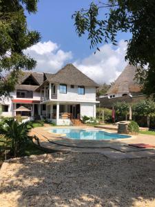 an exterior view of a house with a swimming pool at SouthCoast Outdoors in Ukunda