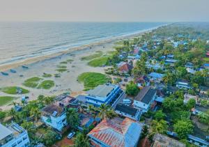 an aerial view of the beach and buildings at Alleppey Holiday Beach Resort by VOYE HOMES , Sea View with Direct Beach Access in Alleppey