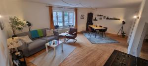 a living room with a couch and a table at Zu Gast im Denkmal St Peter in Dormagen
