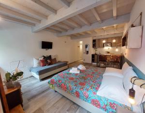 a bedroom with a bed and a desk in a room at Santa Marta Rooms&Studios in Verona