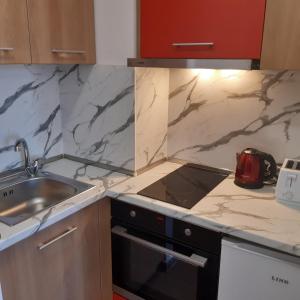 a kitchen with a sink and a counter top at ТЕС Боровец Гарденс in Borovets