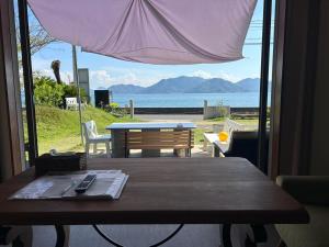 a table in a room with a view of the ocean at Beach Villa Tachibana目の前が海 ペット犬OK Max7名3ユニット BBQ SUP カヤック完備 サイクリング最適 in Onomichi +57 photos