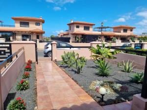 a driveway in front of a house with a car at Casa Azul in Lajares