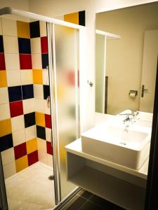a bathroom with a sink and a shower at Village Vacances passion La Buissière in Labeaume +17 photos